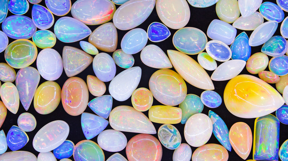 Close-up of a colorful Opal gemstone showing fiery flashes of red, green, and blue