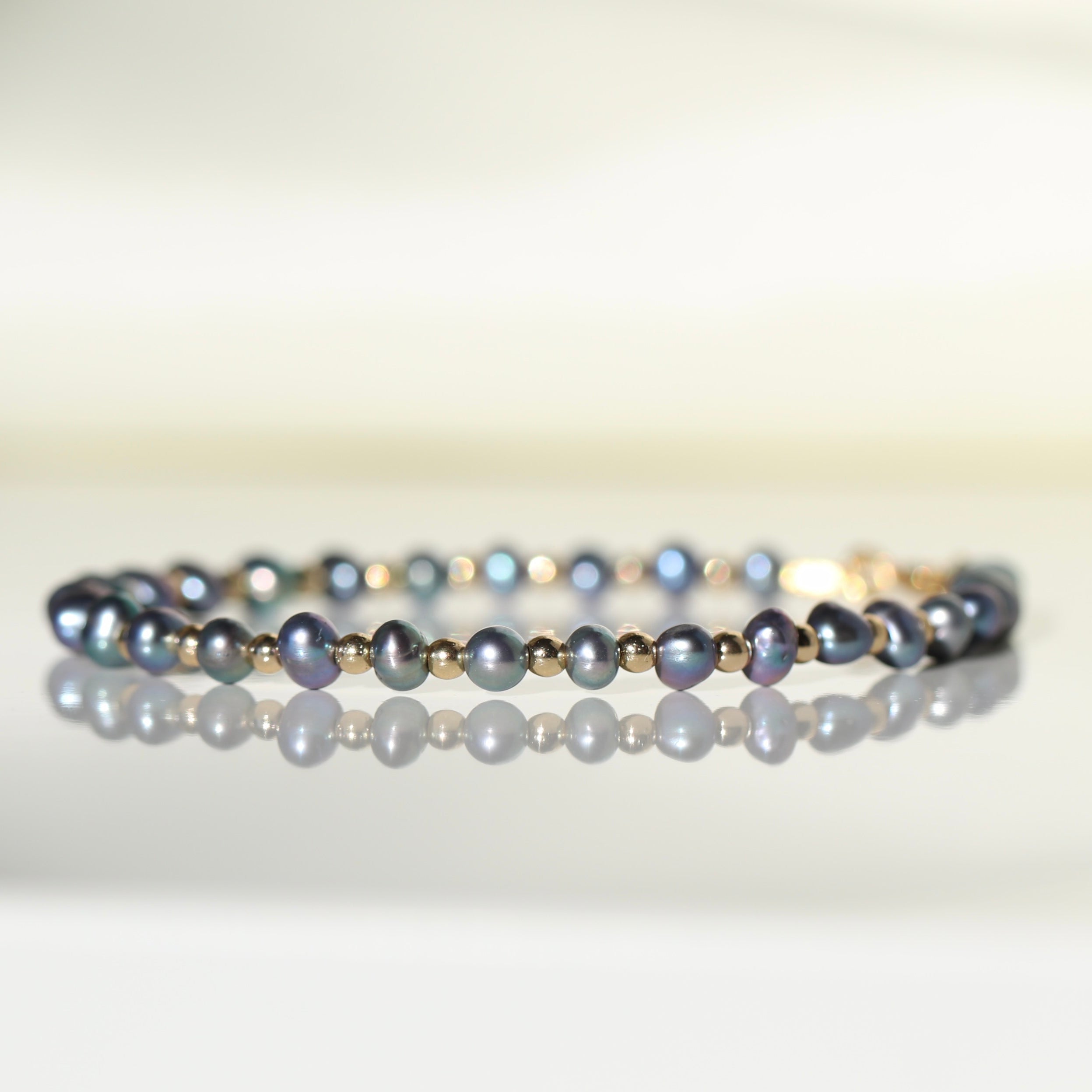 Elegant Tahitian Pearl bracelet featuring black pearls and silver beads by Oberia Jewelry