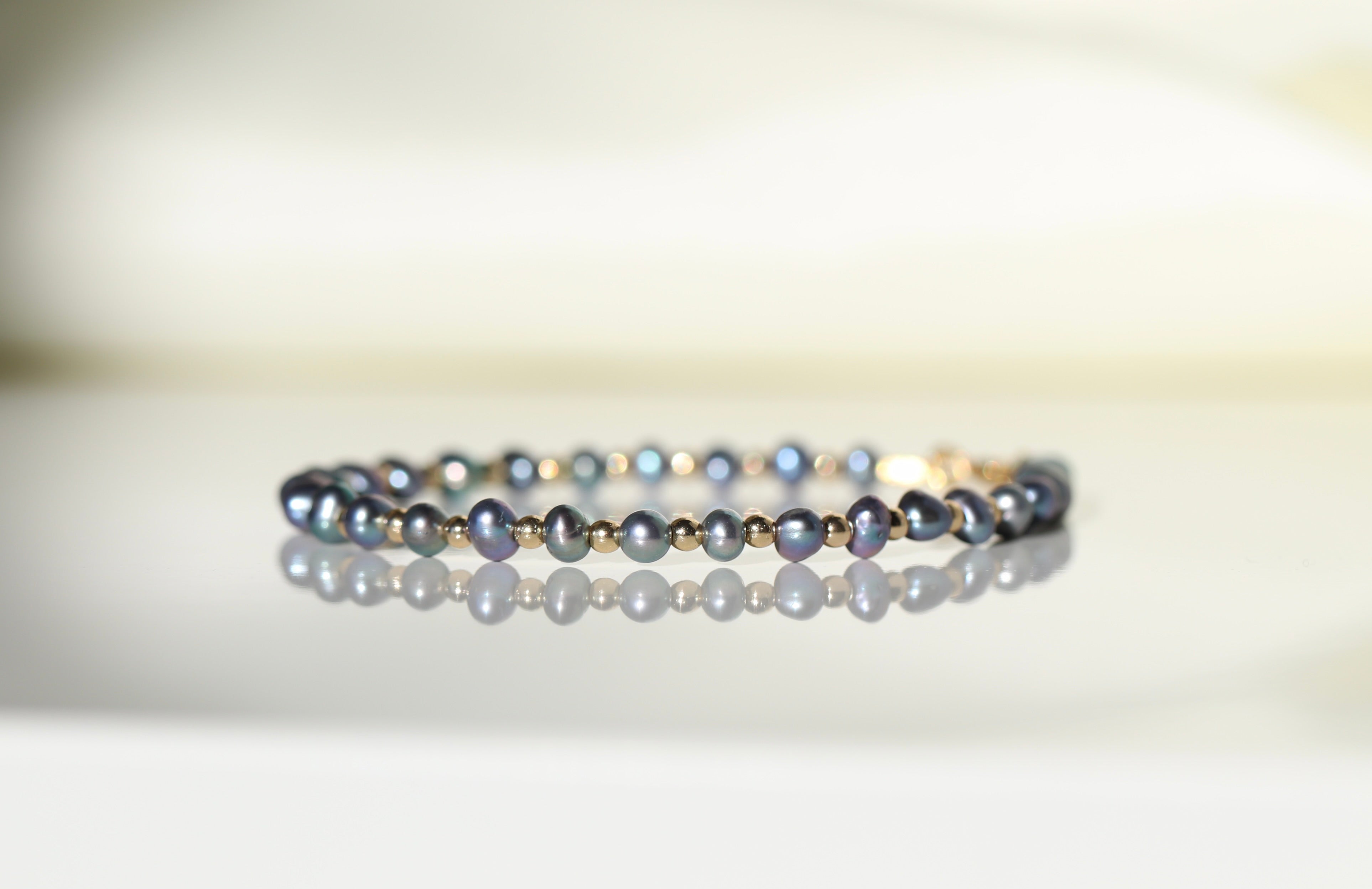 Elegant Tahitian Pearl bracelet featuring black pearls and silver beads by Oberia Jewelry