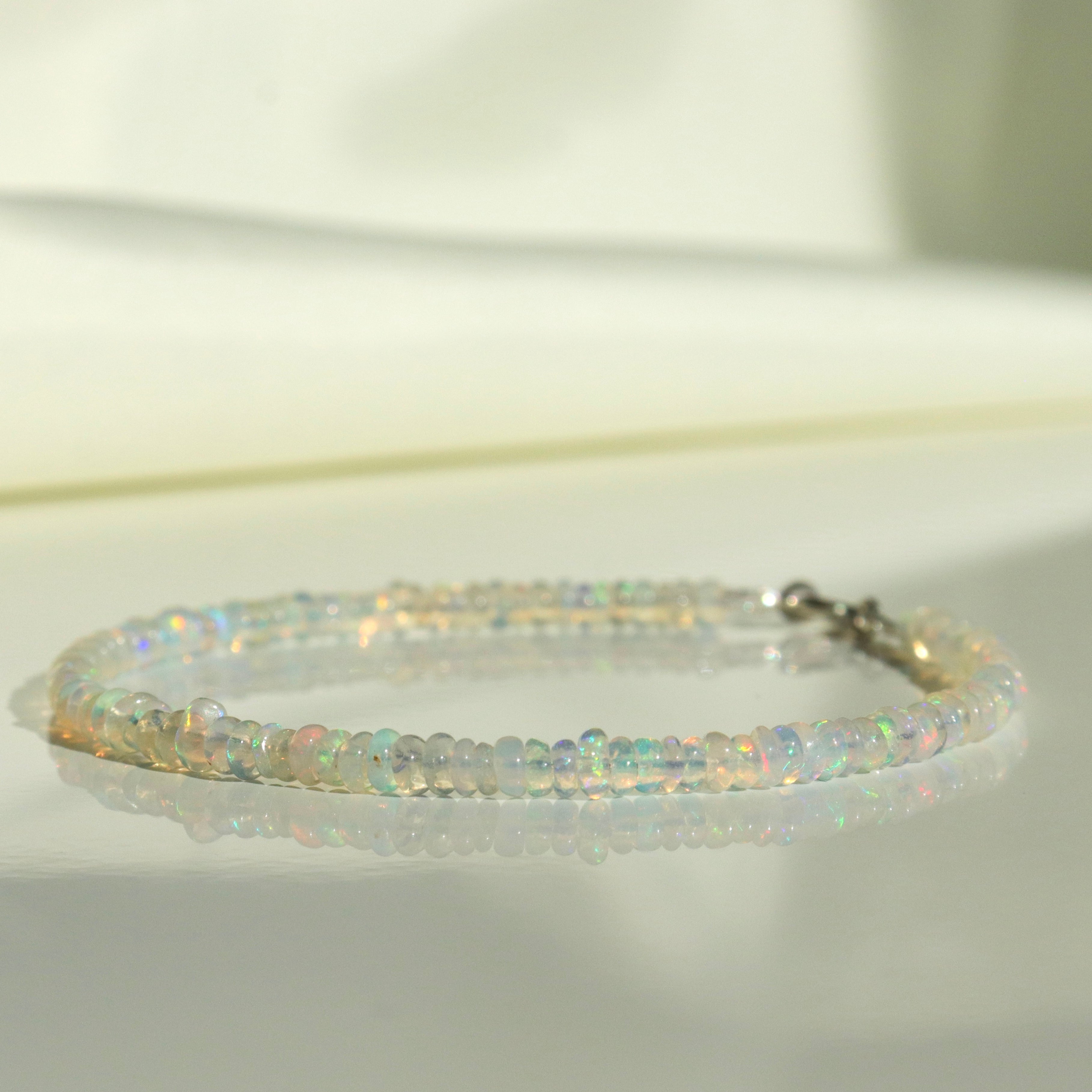 Handmade Ethiopian Opal bracelet, dainty minimalist jewelry with vibrant play-of-color by Oberia