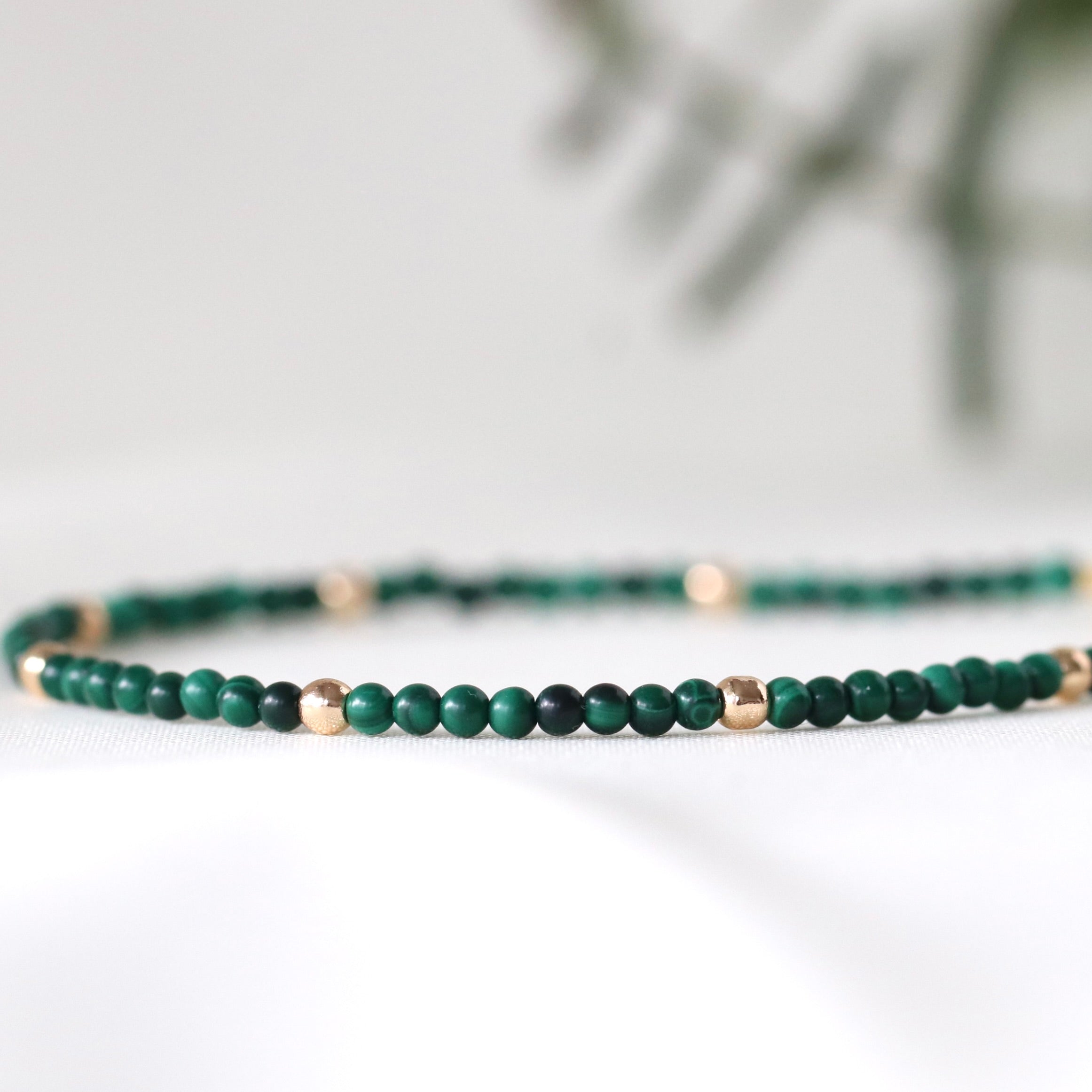 Minimalist malachite bracelet with gold accents, perfect for everyday elegance by Oberia Jewelry