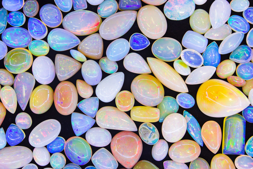 Close-up of a colorful Opal gemstone showing fiery flashes of red, green, and blue