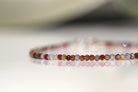 December birthstone bracelet with natural brown zircon and gold accents