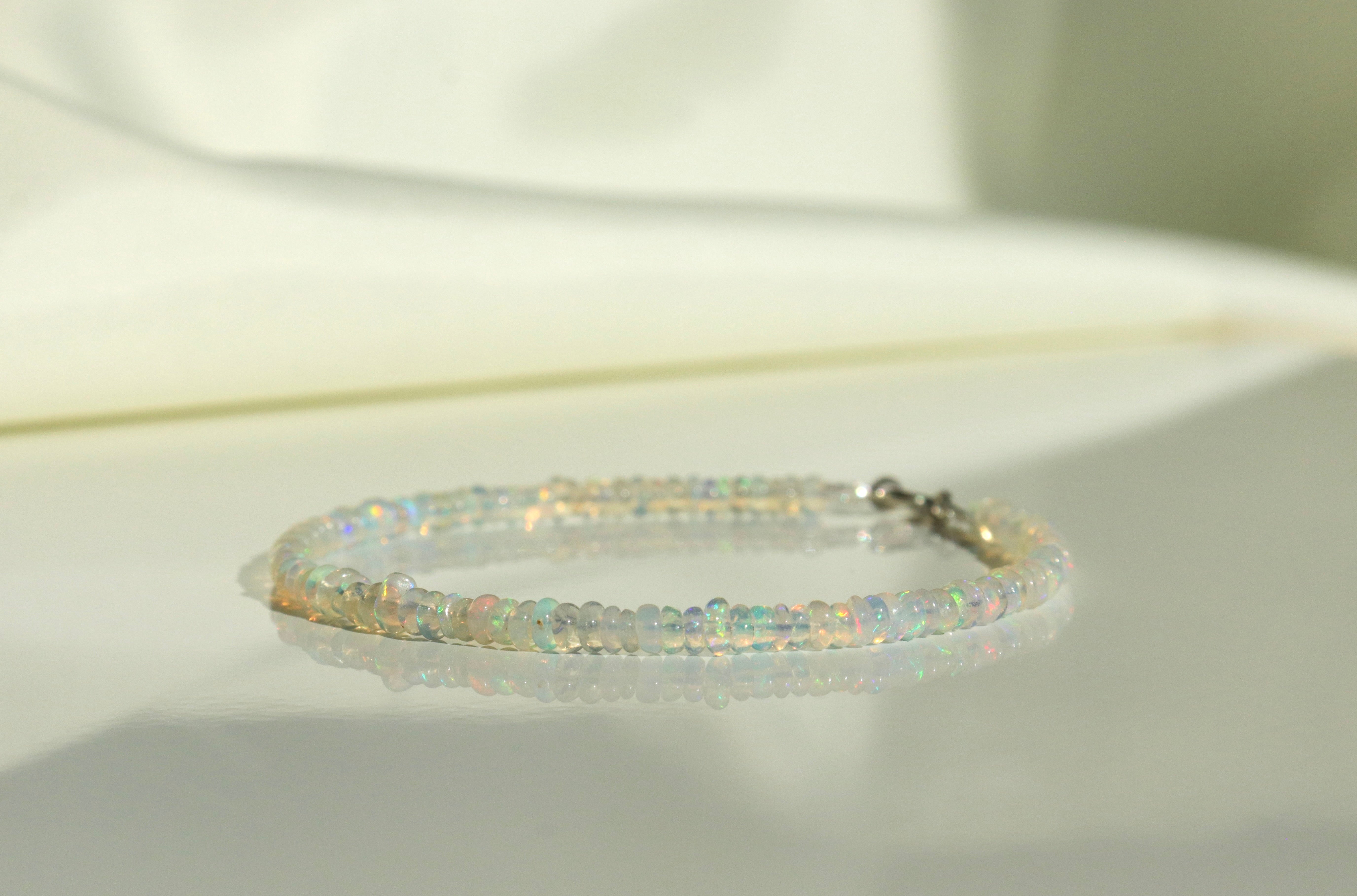 Handmade Ethiopian Opal bracelet, dainty minimalist jewelry with vibrant play-of-color by Oberia