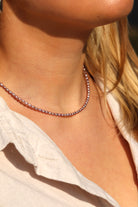 Elegant rose freshwater pearl necklace styled with outfit flat lay, feminine jewelry gift for her or bridal wear.